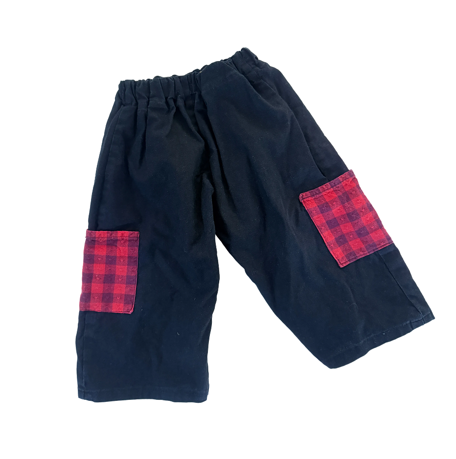 Black pants with red gingham pockets